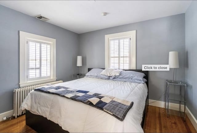 40 Pleasant St, Dover, MA 02030 - bedroom featuring baseboards, visible vents, radiator heating unit, and wood finished floors