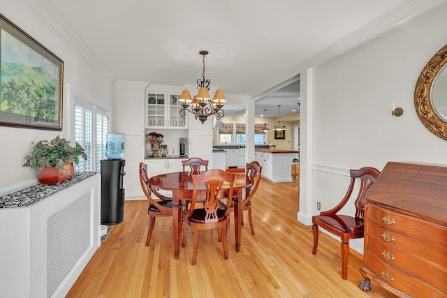 40 Pleasant St, Dover, MA 02030 - dining room featuring crown molding, light wood finished floors, a chandelier, and a wealth of natural light