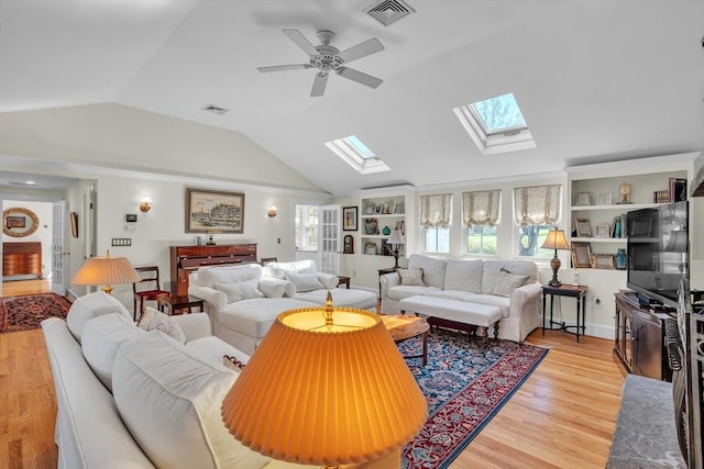 40 Pleasant St, Dover, MA 02030 - living area with a ceiling fan, visible vents, light wood finished floors, and lofted ceiling with skylight