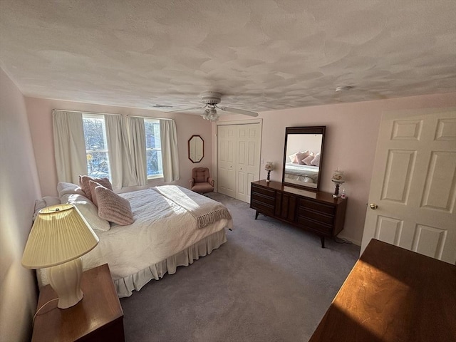 bedroom featuring a closet, visible vents, carpet flooring, ceiling fan, and a textured ceiling