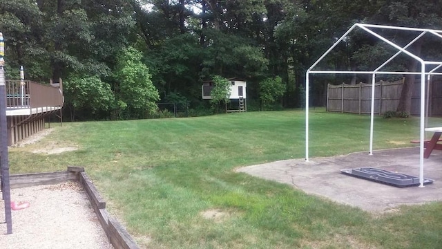 view of yard with fence and an outdoor structure