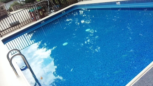 view of swimming pool with fence and a fenced in pool