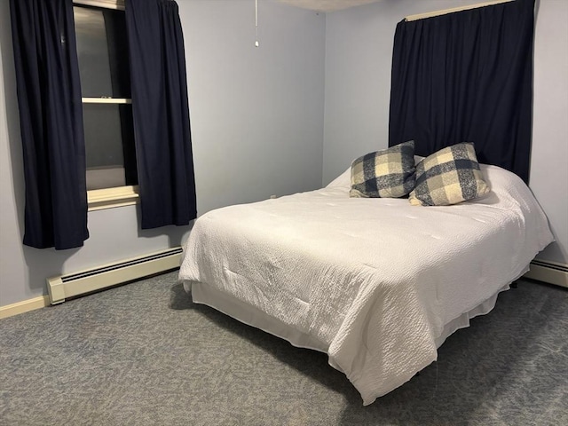 carpeted bedroom featuring a baseboard heating unit and baseboards