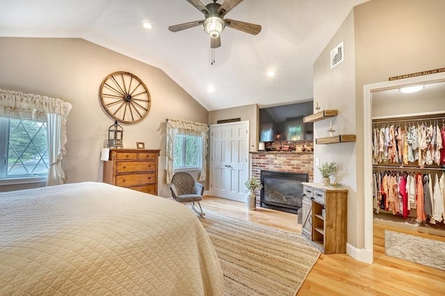 13 Tamarack Rd, Medfield, MA 02052 - bedroom featuring vaulted ceiling, a brick fireplace, light wood-style floors, recessed lighting, and ceiling fan