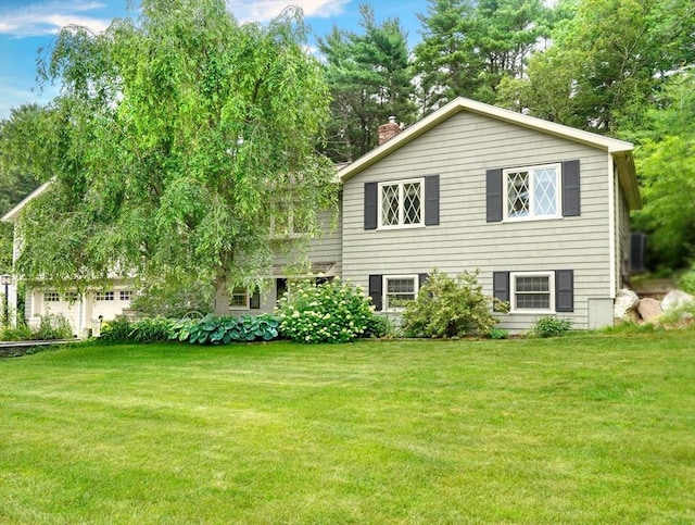 13 Tamarack Rd, Medfield, MA 02052 - view of front of house featuring a chimney, a front yard, and view of wooded area