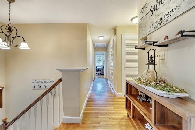 13 Tamarack Rd, Medfield, MA 02052 - hallway with light wood finished floors, attic access, a chandelier, and an upstairs landing