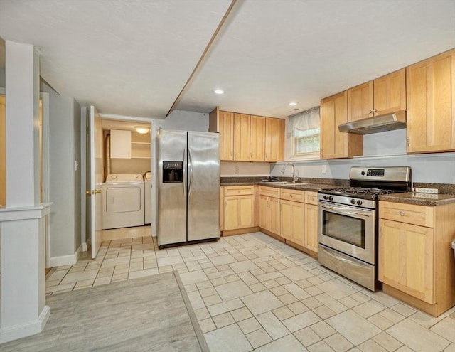 13 Tamarack Rd, Medfield, MA 02052 - kitchen with stainless steel appliances, under cabinet range hood, light brown cabinets, washing machine and dryer, and dark countertops