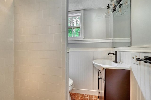 13 Tamarack Rd, Medfield, MA 02052 - bathroom with vanity, a wainscoted wall, and a textured ceiling
