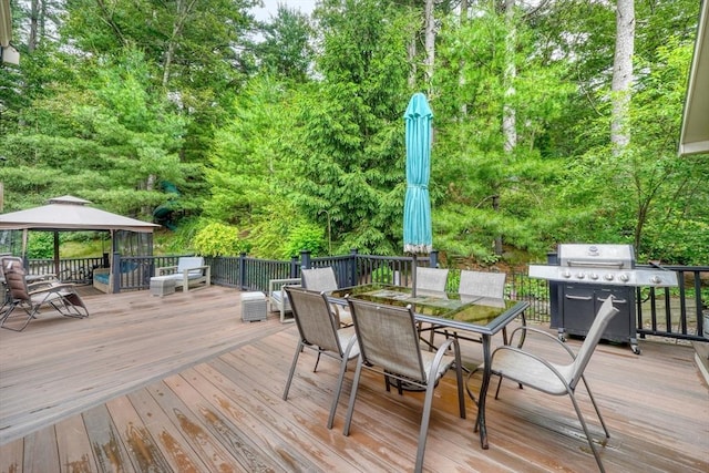 13 Tamarack Rd, Medfield, MA 02052 - wooden terrace with a gazebo, a grill, outdoor dining space, and view of wooded area