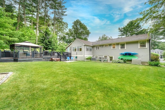 13 Tamarack Rd, Medfield, MA 02052 - back of property featuring a gazebo, a deck, and a lawn