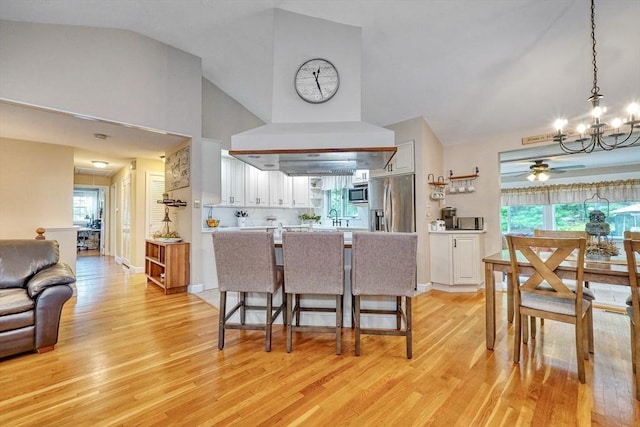 13 Tamarack Rd, Medfield, MA 02052 - kitchen with stainless steel appliances, a chandelier, white cabinetry, light wood finished floors, and a ceiling fan