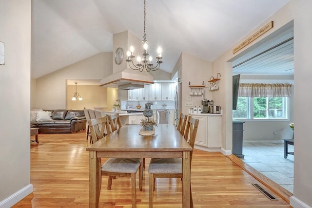 13 Tamarack Rd, Medfield, MA 02052 - dining space with a chandelier, vaulted ceiling, and light wood-style flooring