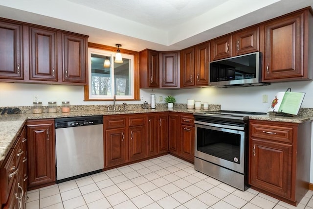 kitchen with a sink, appliances with stainless steel finishes, light tile patterned floors, and light stone countertops
