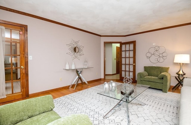 living room with baseboards, ornamental molding, french doors, and wood finished floors