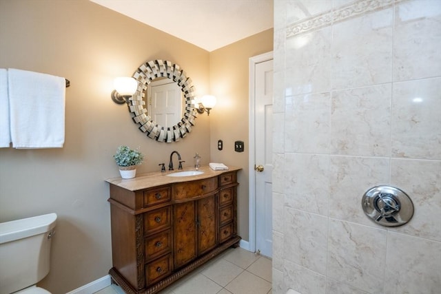 bathroom with vanity, baseboards, tile patterned floors, and toilet