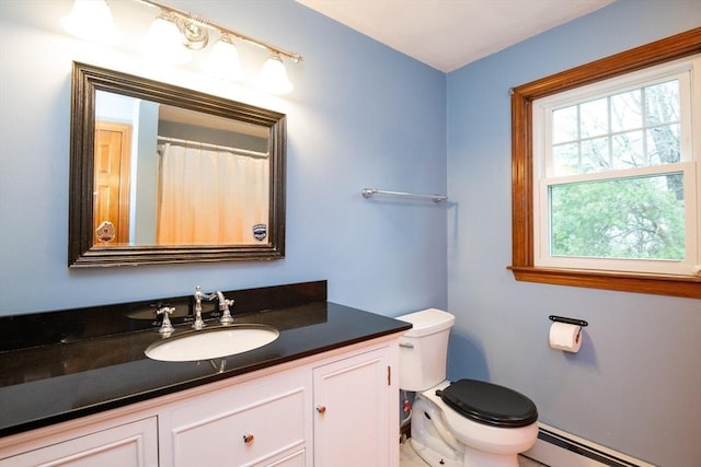 full bathroom with vanity, a baseboard radiator, and toilet