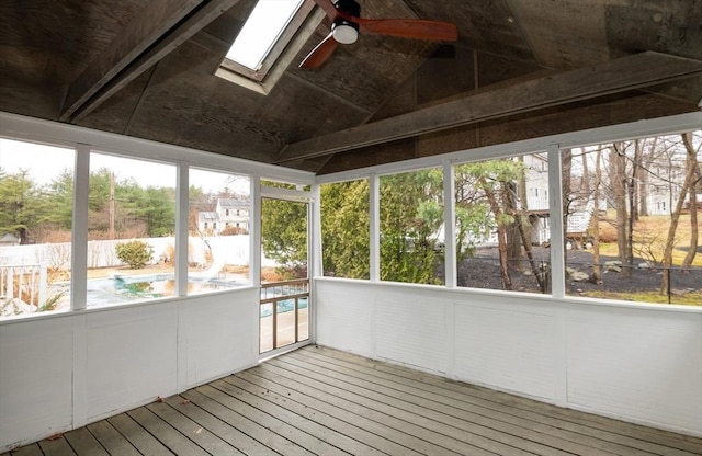 unfurnished sunroom with ceiling fan and a skylight
