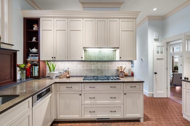 kitchen with stainless steel gas cooktop, open shelves, tasteful backsplash, dark stone countertops, and dishwasher