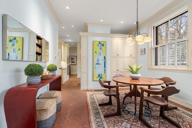 dining area featuring a notable chandelier, baseboards, crown molding, and recessed lighting