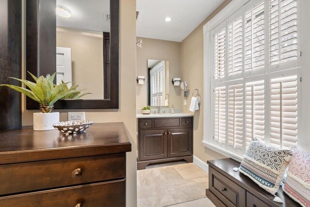 bathroom with recessed lighting, baseboards, and vanity