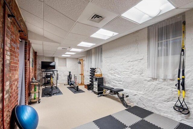 workout area featuring a paneled ceiling, carpet flooring, and visible vents