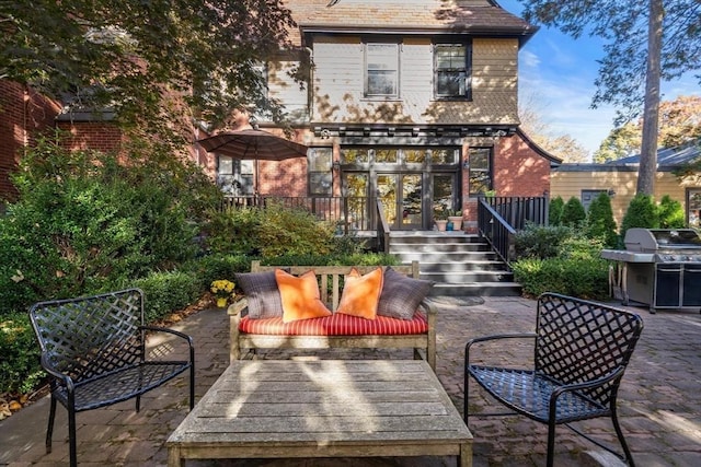 rear view of property with a patio and brick siding