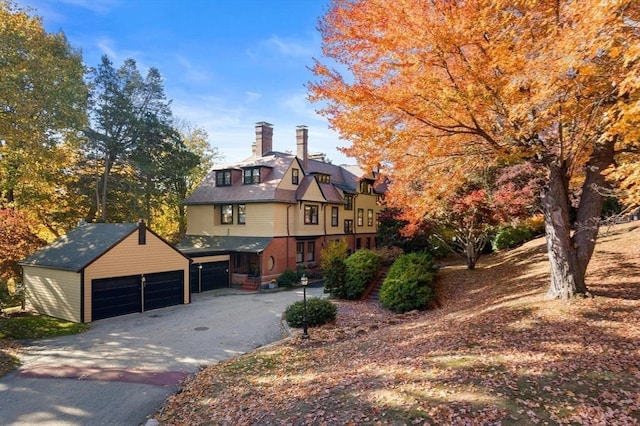 view of front of property with a garage and a chimney