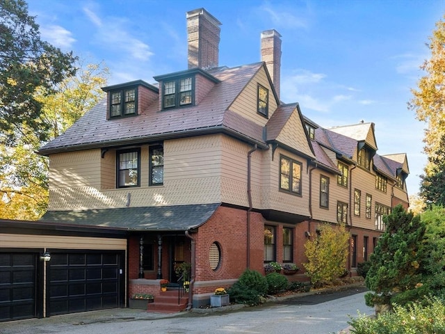 view of front facade featuring brick siding and an attached garage