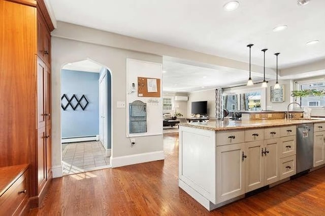 kitchen with a baseboard radiator, dishwasher, light stone counters, decorative light fixtures, and sink