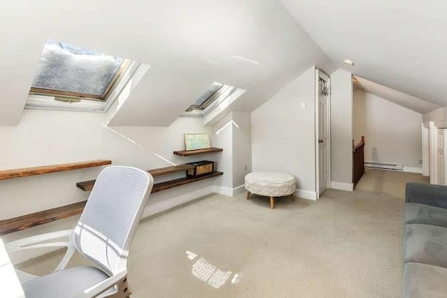 carpeted office space with baseboard heating and lofted ceiling with skylight