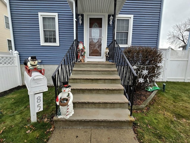 doorway to property featuring a lawn