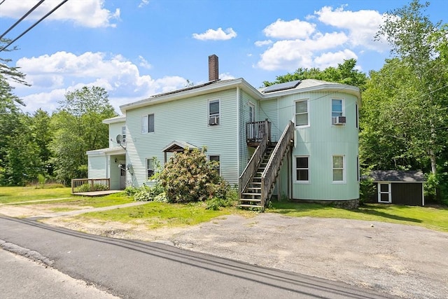 436 Maple St, Winchendon, MA 01475 - view of front of house featuring stairs, solar panels, a chimney, a wooden deck, and a shed