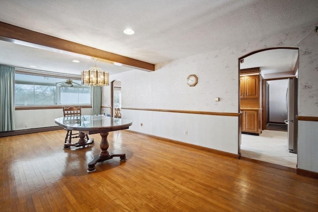51 S St, Granby, MA 01033 - unfurnished dining area featuring light wood-style flooring, a textured ceiling, arched walkways, beamed ceiling, and a chandelier