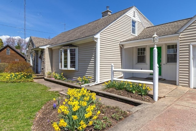 51 S St, Granby, MA 01033 - view of front facade with a shingled roof, a front lawn, a porch, and a chimney