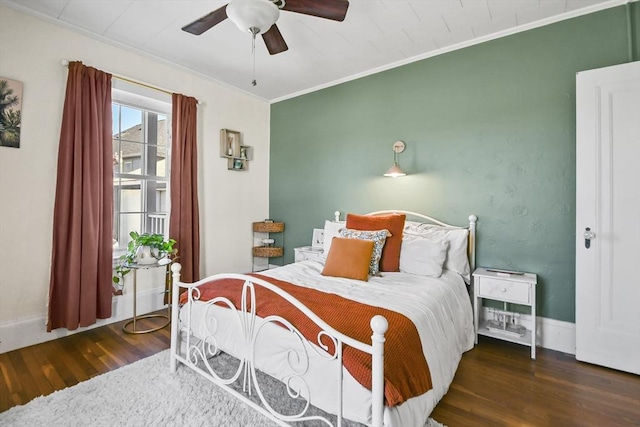 bedroom featuring a ceiling fan, crown molding, and wood finished floors