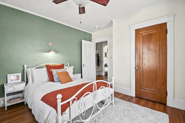 bedroom with baseboards, wood finished floors, a ceiling fan, and ornamental molding
