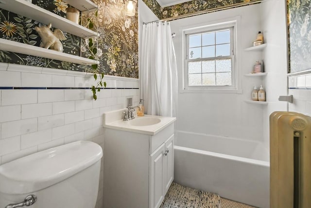 full bathroom with toilet, wallpapered walls, shower / tub combo, wainscoting, and vanity