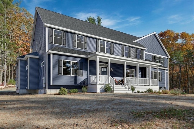 view of front of property featuring covered porch and roof with shingles