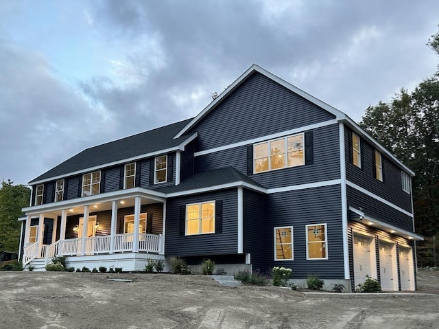 view of front of house with a porch and a garage