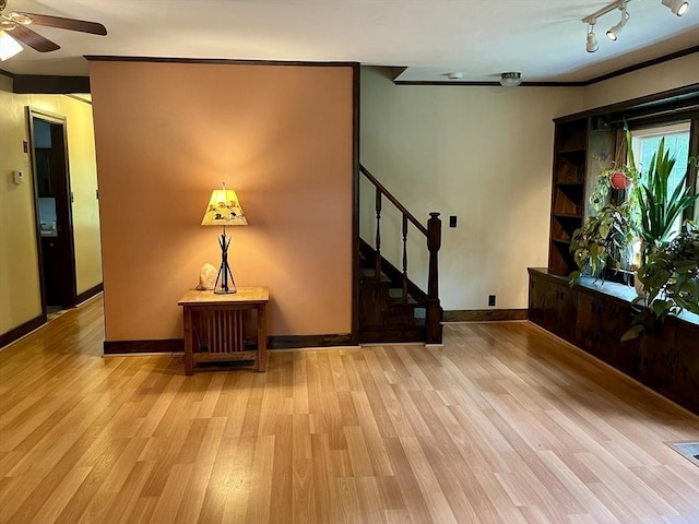 unfurnished room with light wood-style floors, stairs, ceiling fan, and baseboards