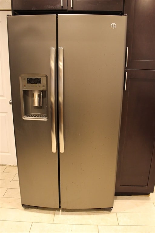 room details with dark brown cabinets and stainless steel fridge with ice dispenser