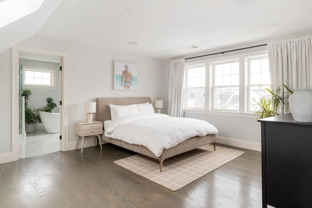 bedroom with dark hardwood / wood-style floors