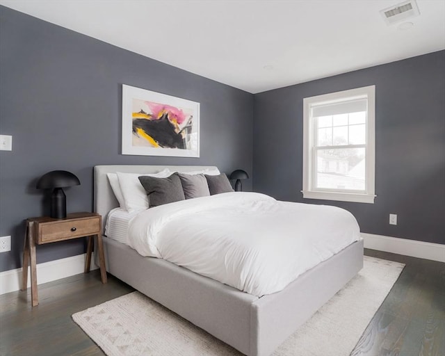 bedroom with dark wood-type flooring