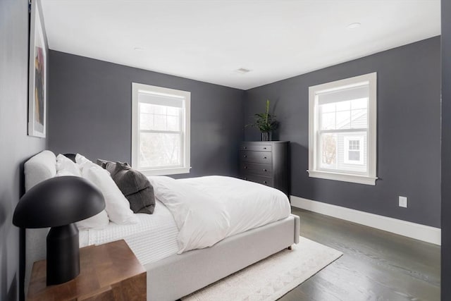 bedroom with dark hardwood / wood-style flooring