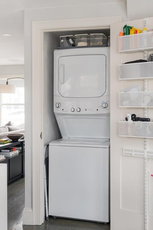 laundry area with stacked washer and dryer