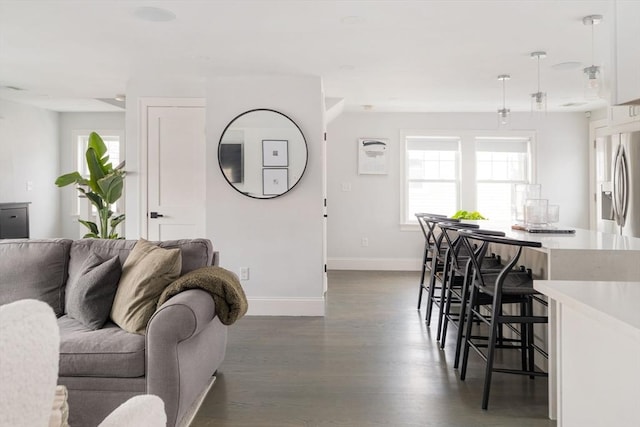 living room featuring plenty of natural light and dark hardwood / wood-style floors