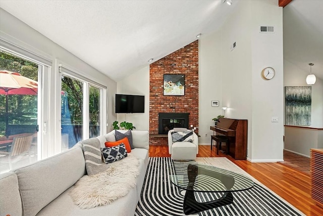 13 Robinwood Rd, Acton, MA 01720 - living room with wood finished floors, a fireplace, high vaulted ceiling, and baseboards