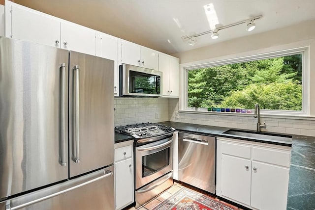 13 Robinwood Rd, Acton, MA 01720 - kitchen featuring appliances with stainless steel finishes, a sink, dark countertops, and backsplash