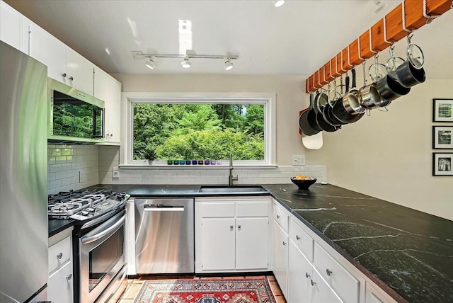 13 Robinwood Rd, Acton, MA 01720 - kitchen featuring stainless steel appliances, a sink, tasteful backsplash, and white cabinetry