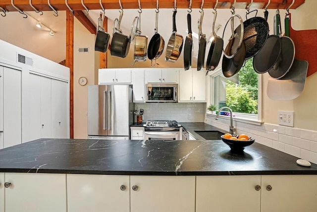 13 Robinwood Rd, Acton, MA 01720 - kitchen with stainless steel appliances, dark countertops, tasteful backsplash, and a sink
